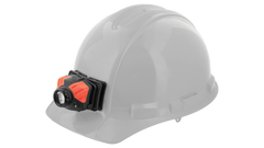 A hard hat with an LED headlamp attached by the COAST adhesive helmet mount. 