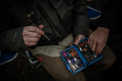 Fisherman using LED Flashlight to Illuminate Tackle Box, lifestyle photo