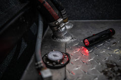 Red LED Flashlight Illuminating Steel Plate and Engine Pumps, lifestyle photo